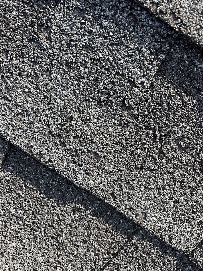 Close-up of hail damage to asphalt shingles