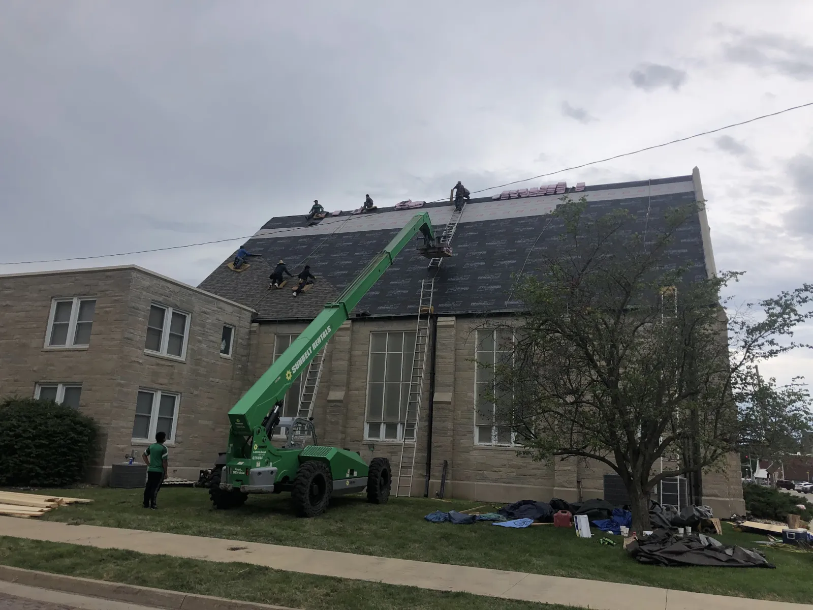 A Binnacle roofing crew re-roofing a large building on a job site