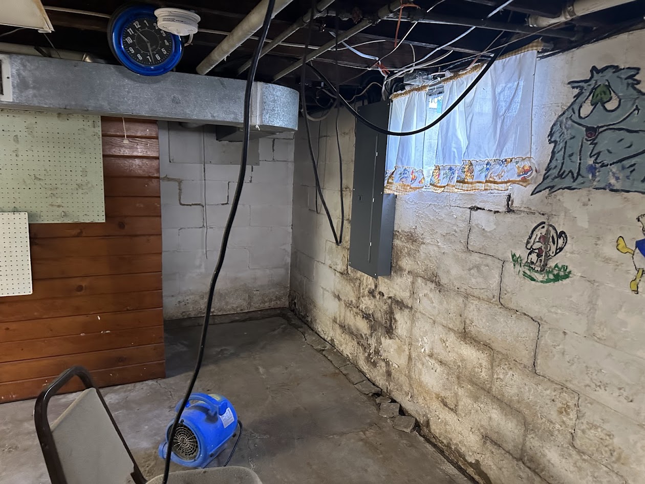 Binnacle air mover drying a water-damaged basement